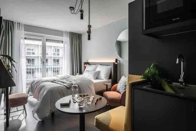 Modern Revo Munich guest room for bleisure travel, remote work, and business meetings.