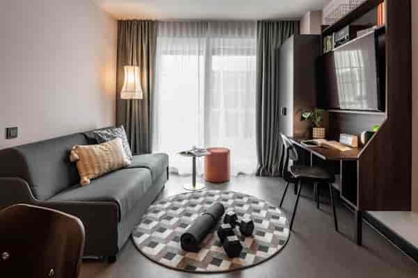 Modern Revo Munich hotel room with workspace for bleisure travel and business accommodation.