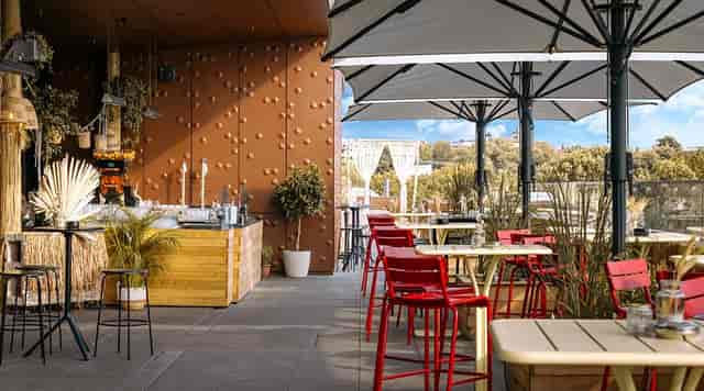 Rooftop restaurant at Deutsches Museum: modern high-top seating for corporate networking events.