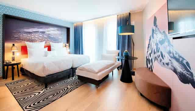 Modern twin hotel room at NYX Hotel Munich for group travel and family stays.