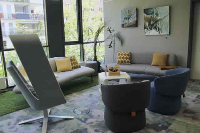 Casual breakout space with soft seating for networking and fireside chats.