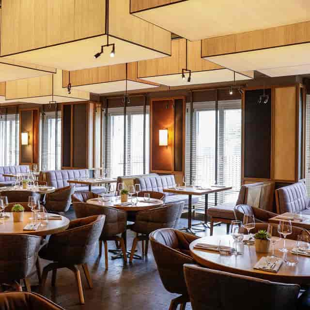 Upscale Louis Grillroom restaurant with banquette seating for corporate dinners and VIP events.
