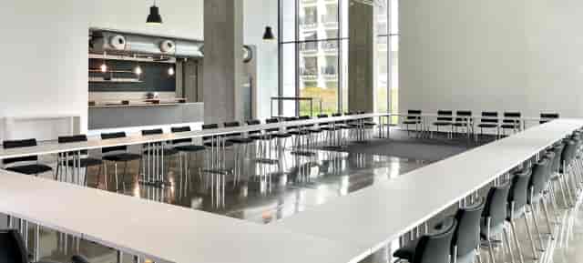 Industrial studio meeting space with U-shape seating for professional events and workshops.