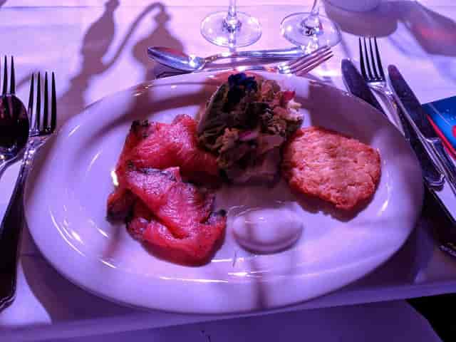 Smoked salmon appetizer at Wappenhalle Munich gala event, poor lighting.