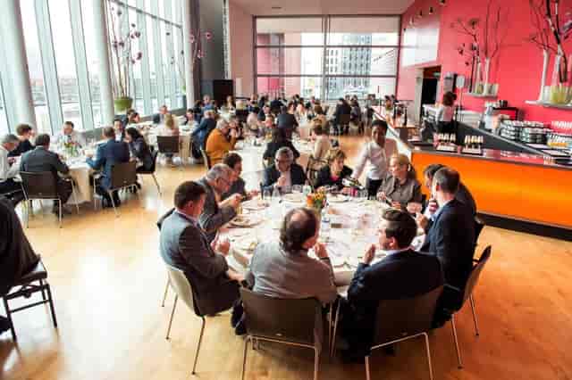 Corporate luncheon setup with round tables at Maasfoyer, New Luxor Theater for business events.