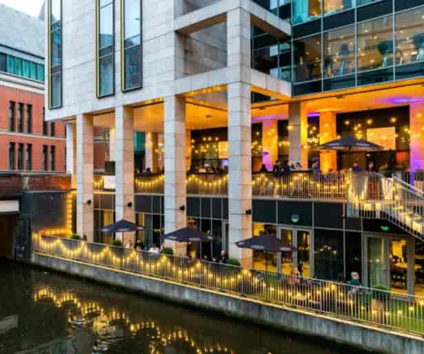 Stylish Holiday Inn Manchester venue for events with modern exterior and enchanting lights.