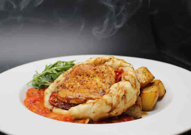 Bistro Live Leicester banquet entrée: steaming rustic dish for corporate events and party catering.