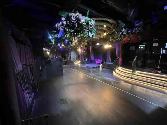 Soho venue with stage, floral ceiling, and theatrical drapes for experiential events and launches.