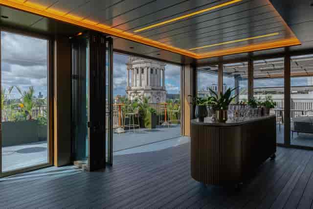 Sophisticated Central London rooftop event space with city views and modern furnishings.
