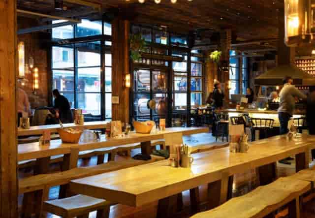 Industrial-chic venue hire for networking events and receptions with rustic communal seating.