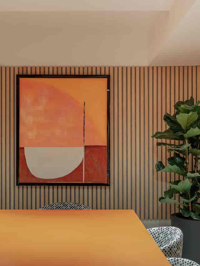 Modern meeting room with abstract art and wooden panels for creative events.
