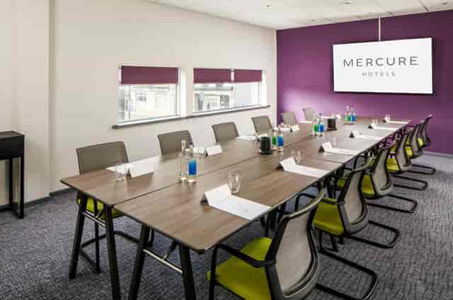 Boardroom-style County Suite at Mercure Bedford with natural light for professional meetings.