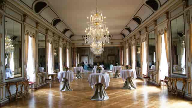 Elegant networking reception at Coudenberg Palace ballroom, historic event venue.