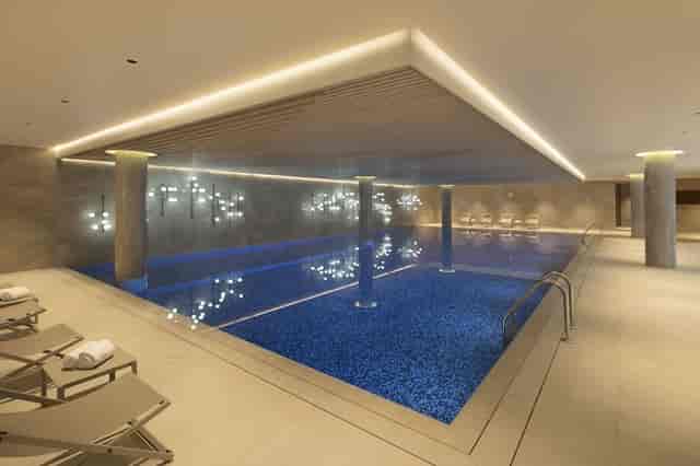 Luxury indoor pool at Tangla Hotel Brussels for upscale corporate retreats and VIP wellness events.