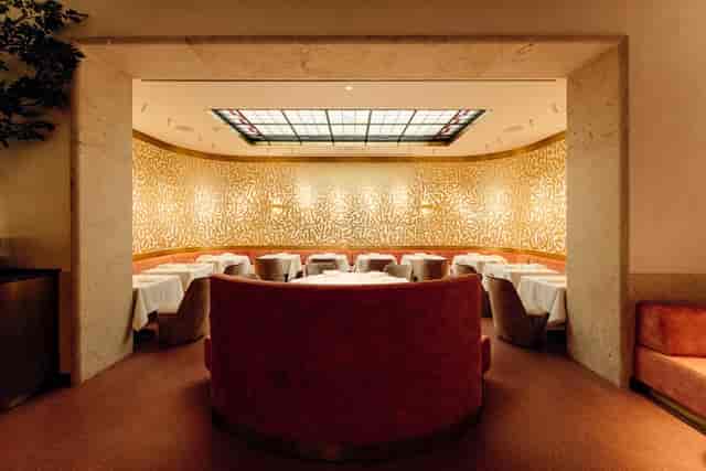 Private dining room at La Villa Lorraine with gold-accented circular banquette for VIP board events.
