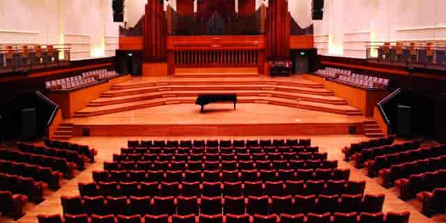 Flagey concert hall auditorium with tiered seating for corporate plenary sessions and keynotes.