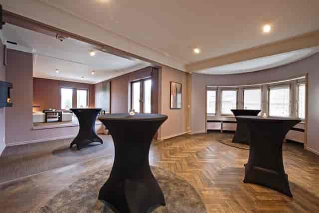 Villattitude function room with herringbone floors, ideal for corporate mixers and social events.