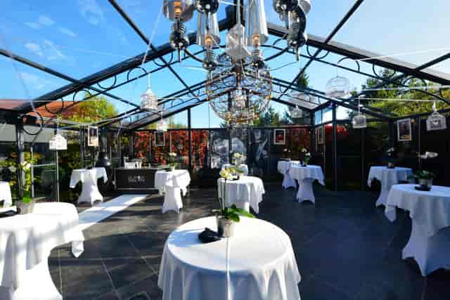 Orangerie at Aromate glass conservatory with crystal chandelier for upscale cocktail receptions.