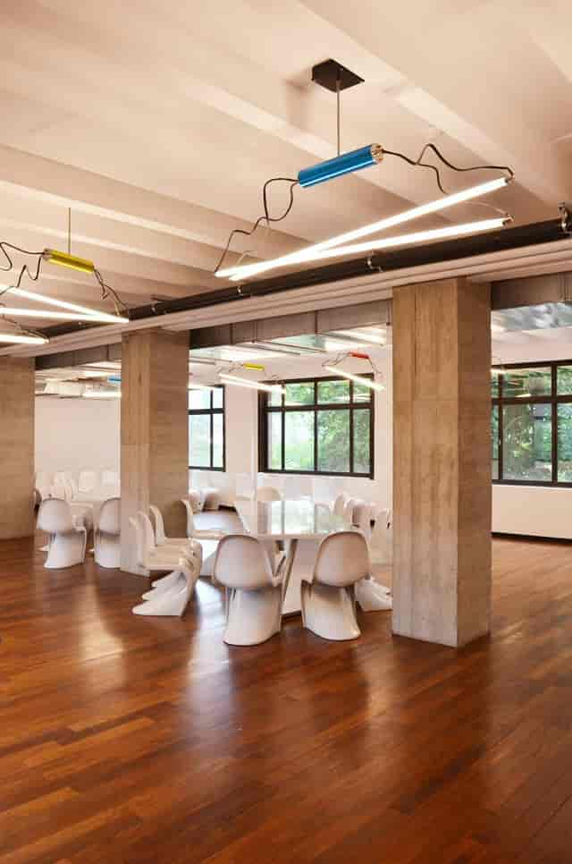 Glass Paving Block Room: Industrial workshop space with wood floors for design sessions.