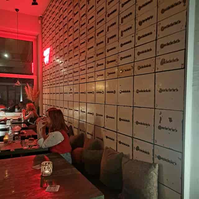 Industrial-chic restaurant venue with vintage locker wall for networking events.