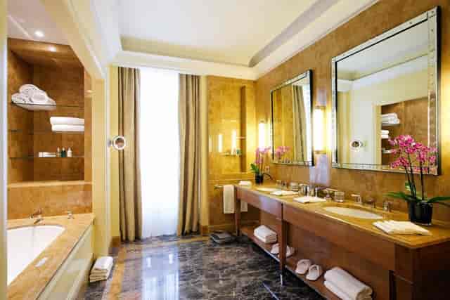 Paola in luxury Le Plaza hotel suite bathroom, VIP speaker accommodation, executive travel.