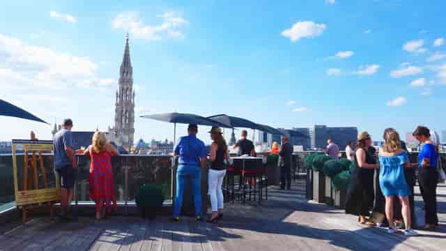 Duquesnoy A+B rooftop networking reception, Brussels city view, corporate event venue.