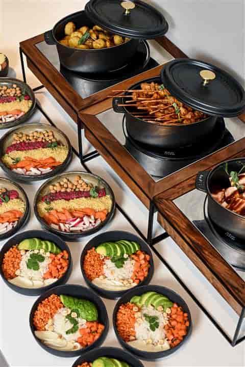 Chef-curated buffet bowls at a corporate event catering layout for efficient service.