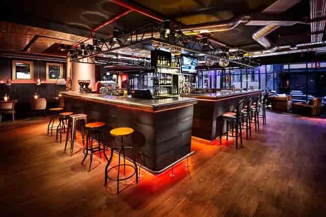 Industrial-chic Brussels event venue with mood lighting for networking and evening receptions.