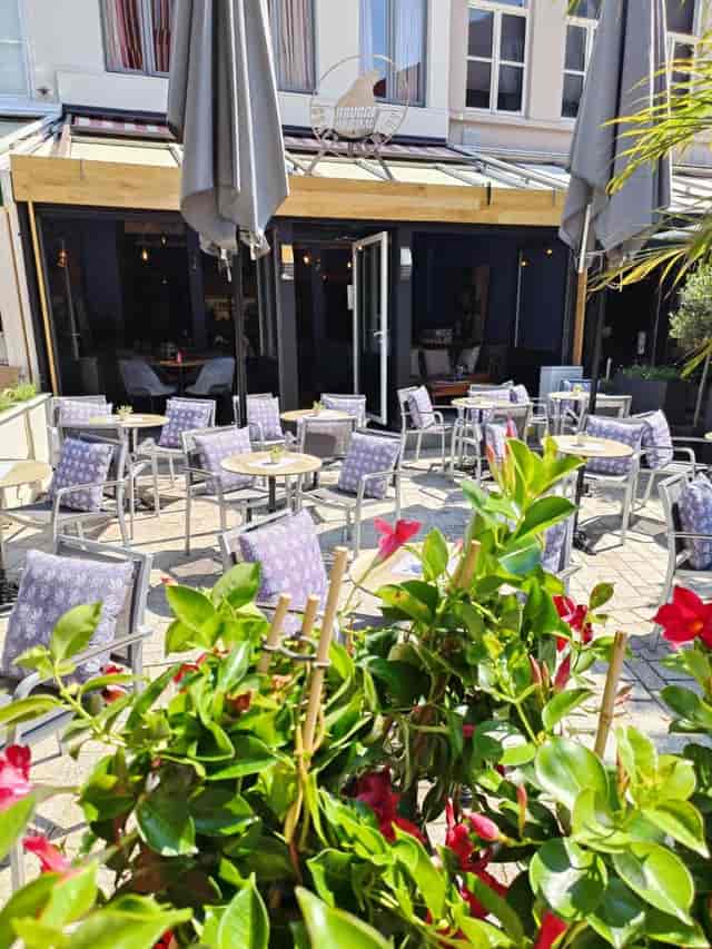 Outdoor hotel terrace with bistro seating for networking and cocktail events in Brugge.