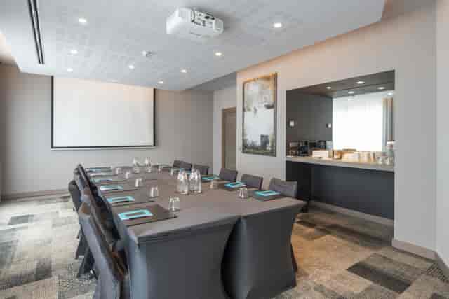 Konrad Adenauer boardroom with projector screen, ideal for professional meetings and presentations.