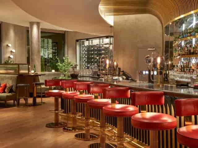 Jourdan Lounge wine cellar with plush red seating for VIP receptions and networking events.