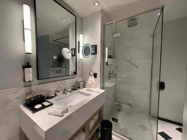 Modern hotel bathroom at Sofitel Brussels, luxury executive retreat suite for VIP events.