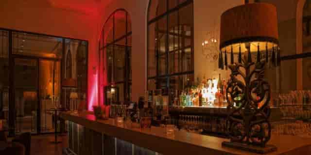 Cocktail bar at The Dominican with warm lighting, ideal for intimate event receptions and parties.