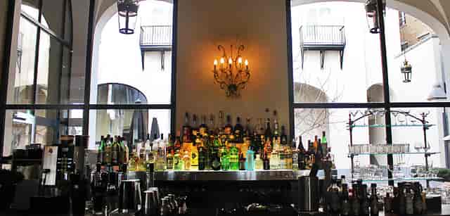 The Dominican cocktail bar for networking event or corporate reception with dramatic lighting.