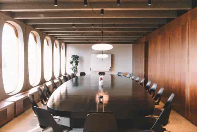Mid-century boardroom with large table for executive strategy and corporate meetings.