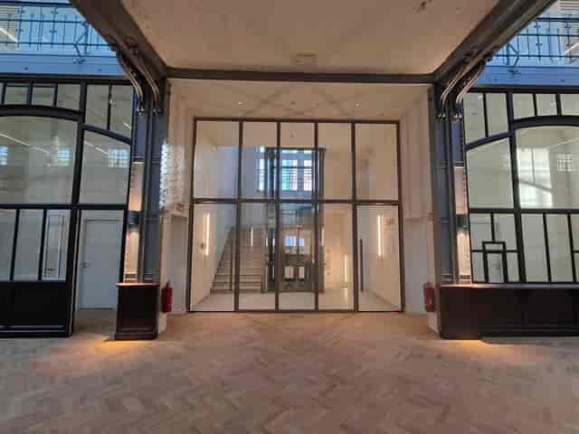 Industrial-chic Hôtel des Douanes venue, hardwood floors for corporate event or networking reception.