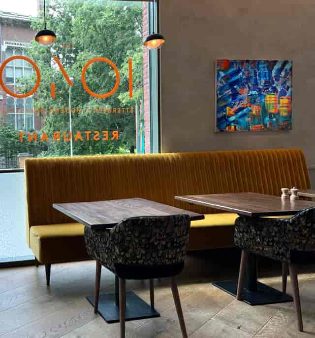 Modern brasserie breakout space with vibrant banquette seating for networking and strategy events.