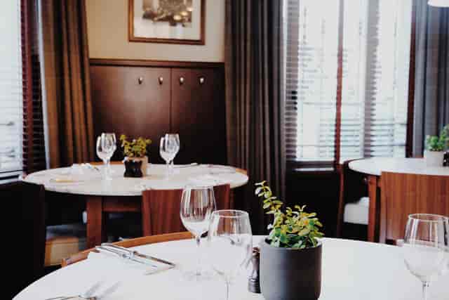 Le Mess main dining room with wood paneling for executive lunch meetings and breakout sessions.