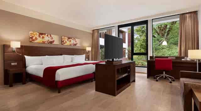 Modern hotel room with workspace at Dolce La Hulpe Brussels for business travel and corporate events.