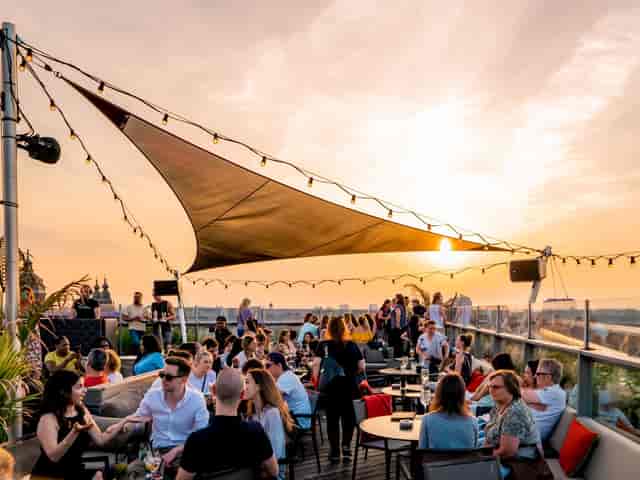 Rooftop networking reception at The 1040 with string lights for corporate event and venue hire.