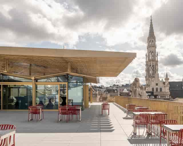 Modern open-air cafe venue with city skyline view for corporate breakout space or cocktail event.