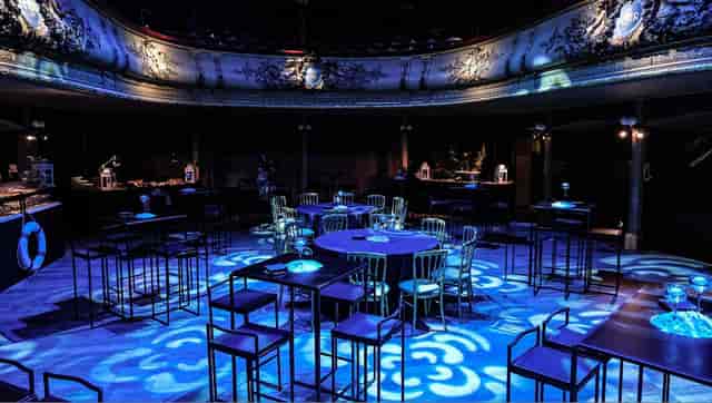 Salle des Clés event venue with moody lighting for evening receptions and corporate gala events.