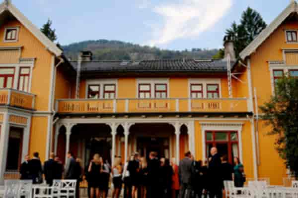 Mustard-yellow historic Legenes hus conference center for corporate retreat and networking events.
