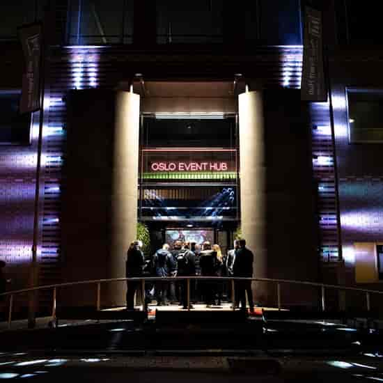 Oslo Event Hub exterior with dramatic architectural lighting for corporate event venue entrance.