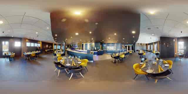 Modern Radisson Blu Nydalen conference room with yellow chairs for corporate events and networking.
