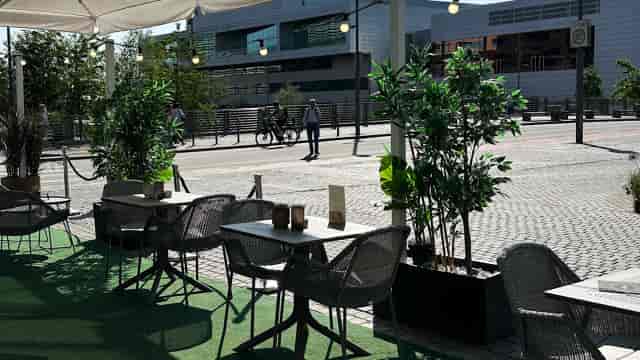 Outdoor networking area at Clarion Hotel Oslo with bistro tables and greenery for events.