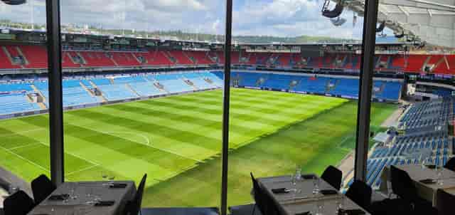 Premium hospitality suite overlooking stadium pitch for corporate events and VIP networking.
