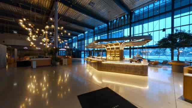 Modern NOVA Spektrum venue with central bar for corporate events and networking receptions.