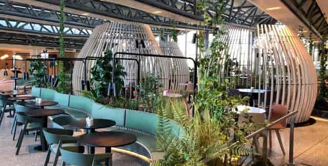 Hybrid Studio at Oslofjord Convention Center: Biophilic breakout space for event networking.