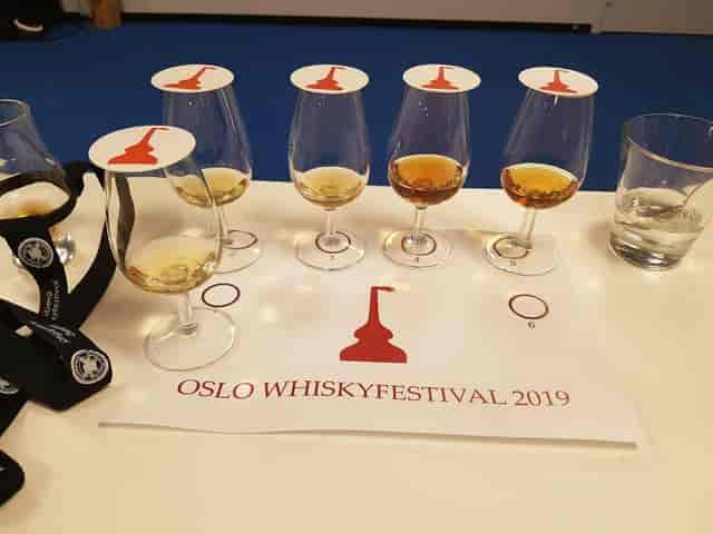 Nansen spirits event F&B setup with branded glassware and placemats at Thon Conference.
